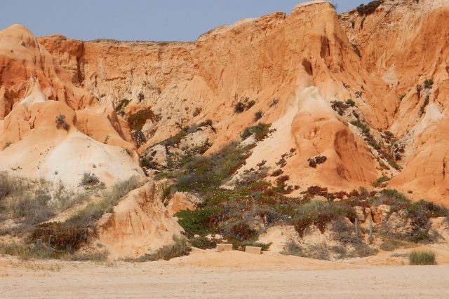Red sandstone cliffs above an empty Algarve beach near Albufeira.