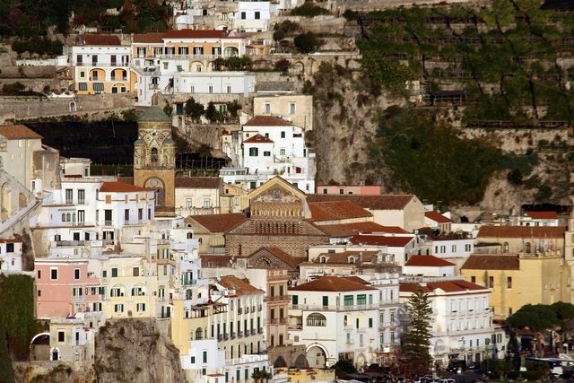 Amalfi stacked up the cliff behind its seafront, the cathedral bell tower among the houses.