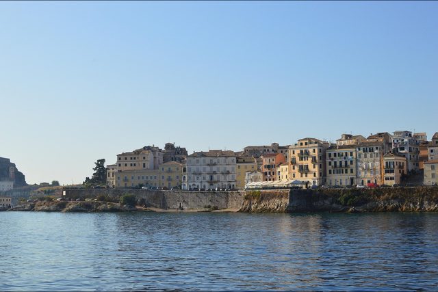 Tall painted houses along the sea wall at Corfu Town.