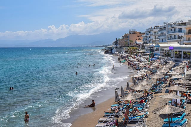 Sunbeds and parasols along the beach at Hersonissos.