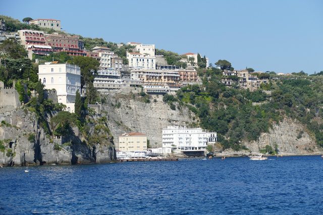 The cliffs at Sorrento, buildings along the top and at the water's edge.